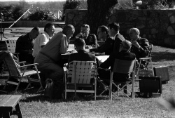 Pres. Lyndon B. Johnson meeting with Joint Chiefs of Staff around picnic table on LBJ Ranch front lawn.