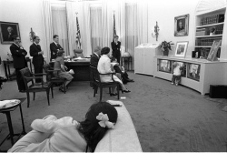 President Lyndon B. Johnson, family members, and staff watching the President's announcement of bombing halt on television