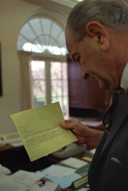 President Lyndon B. Johnson reading the news ticker