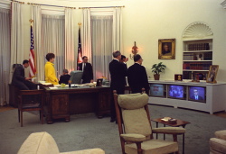 President Lyndon B. Johnson and members of his staff watch TV news reports concerning the assassination of Dr. Martin Luther King